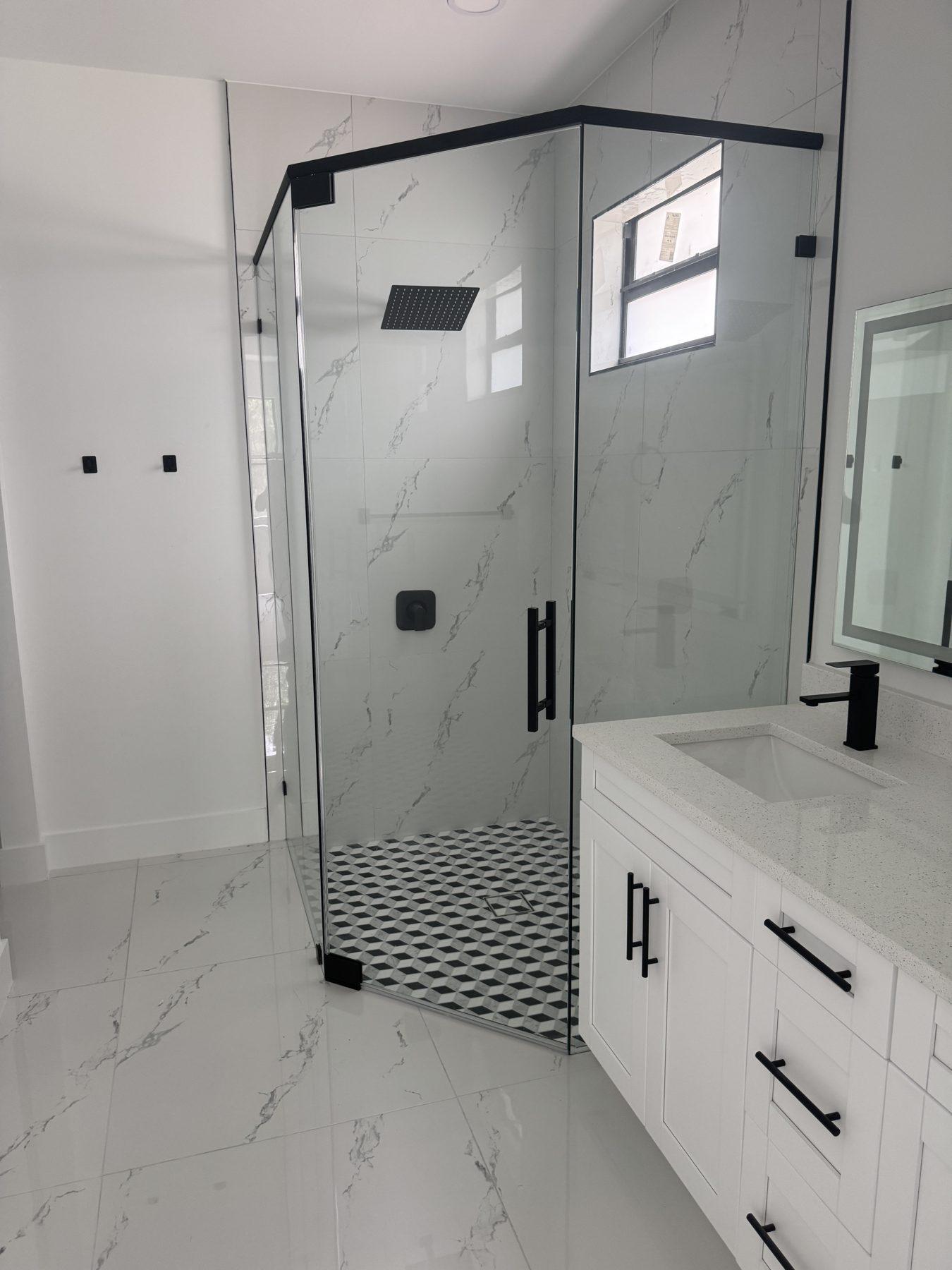 Walk-in glass shower with marble walls