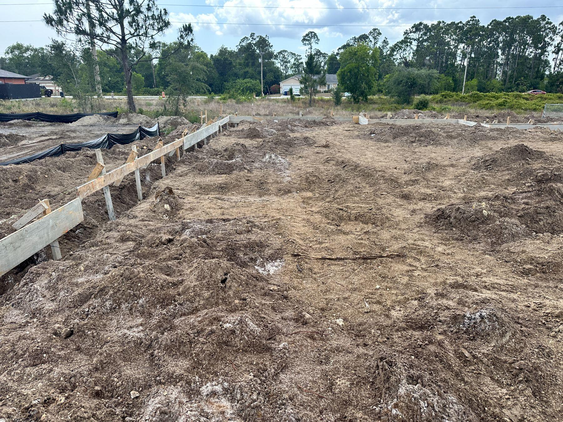 Footing forms staked out on a cleared lot
