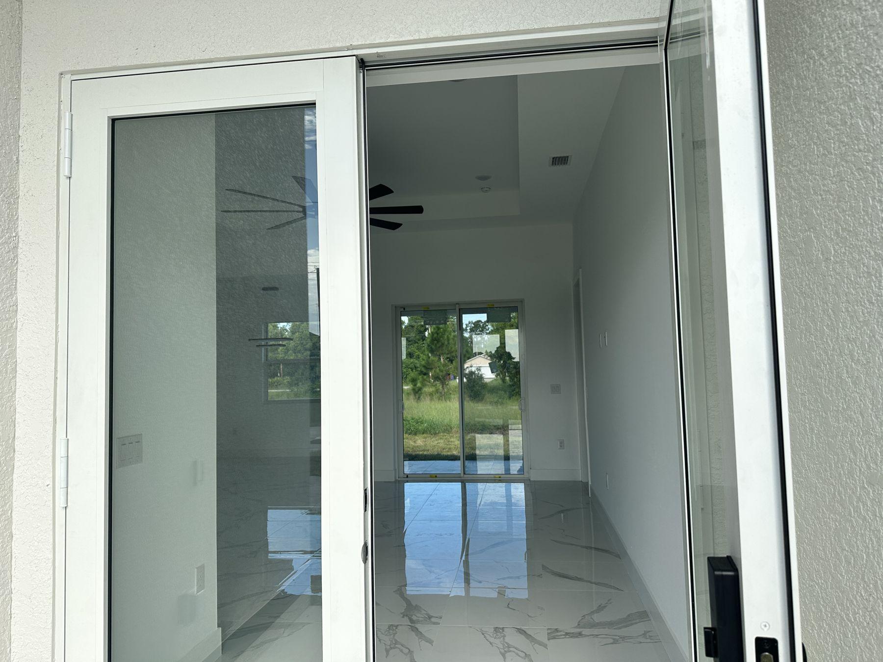 Living area with sliding glass doors and tile floors