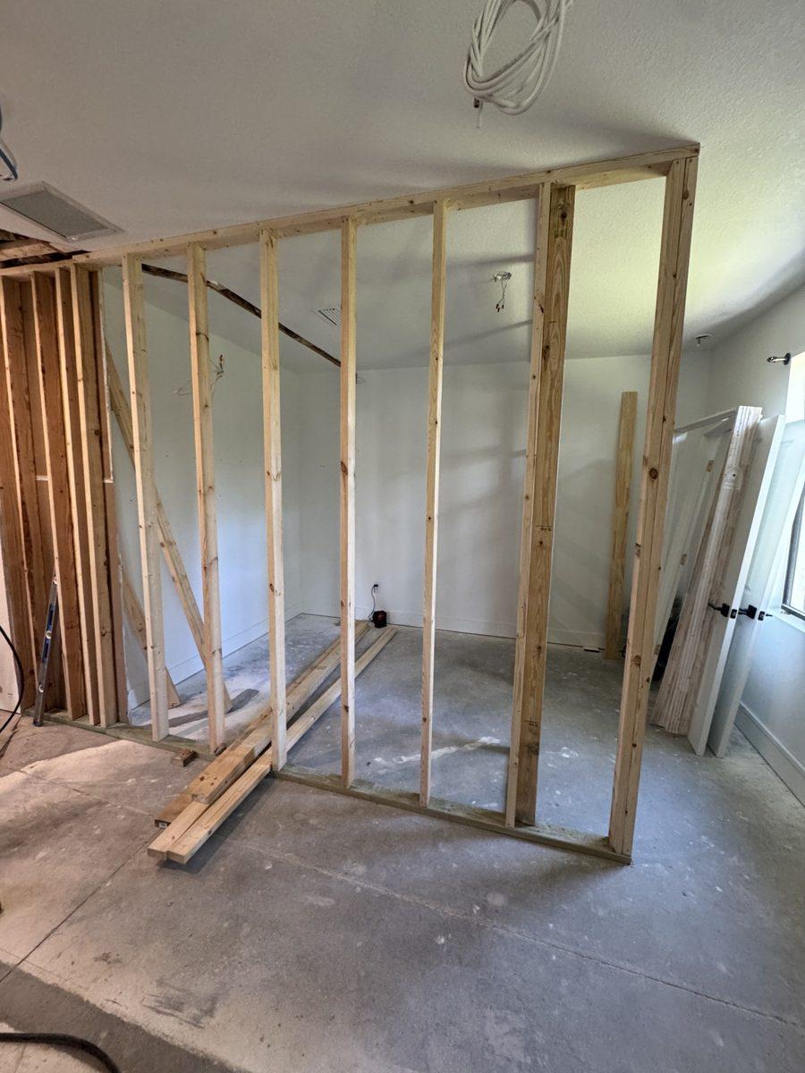New wood stud wall framed inside a bedroom