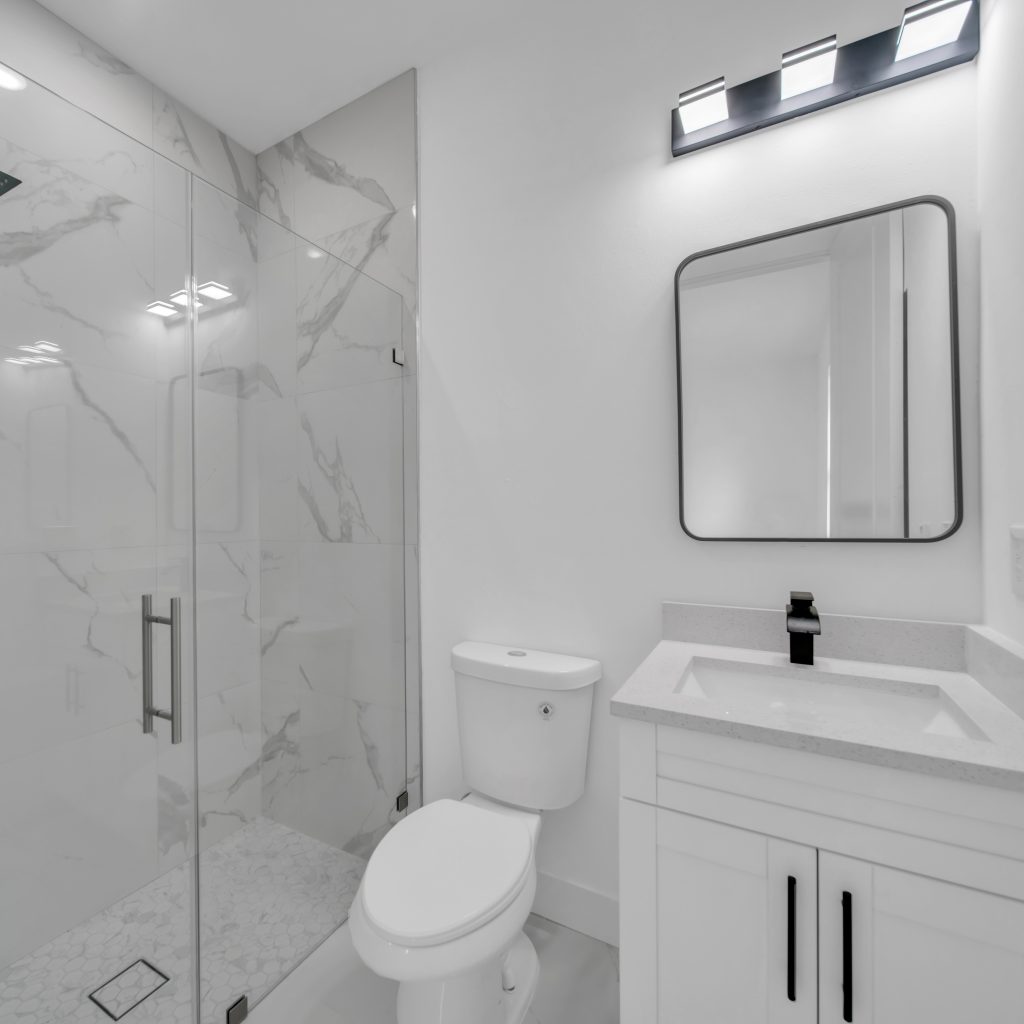 Bathroom remodel with walk-in shower, floating vanity and matte black fixtures in Southwest Florida
