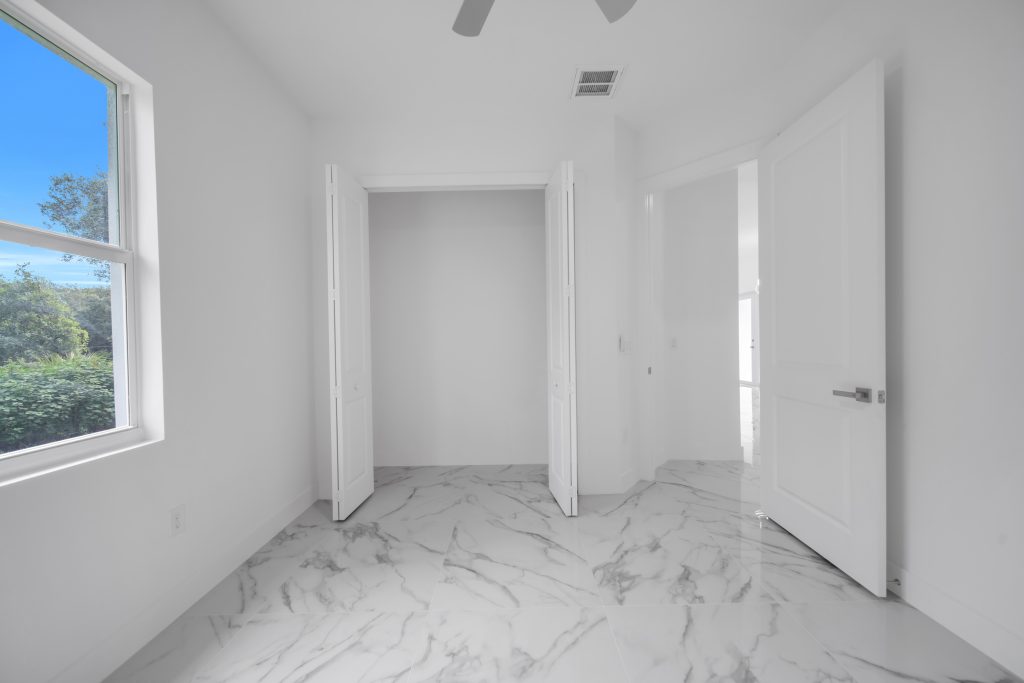 Bedroom with porcelain tile flooring in a newly constructed Lehigh Acres, FL home